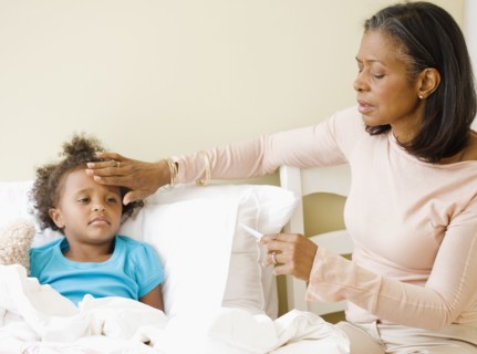 African grandmother checking granddaughter's temperature