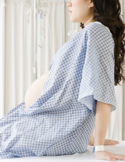 Pregnant Asian woman having checkup in doctor's office