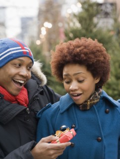 African man giving girlfriend Christmas present