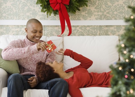 African man giving girlfriend Christmas present