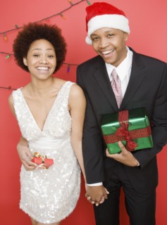 African couple holding Christmas presents