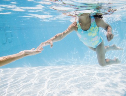 Hispanic girl swimming in pool