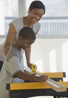 African mother and son woodworking together