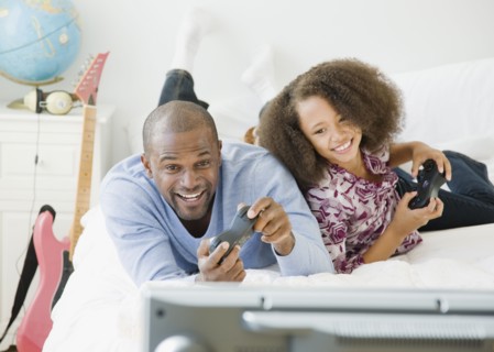 African father and daughter playing video game