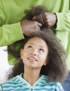 African father styling daughter's hair