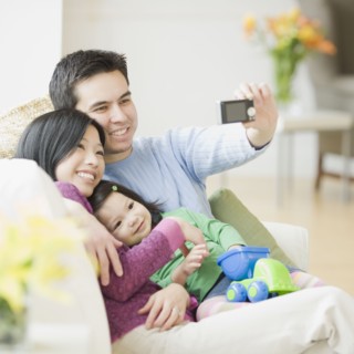 Family on couch posing for photograph