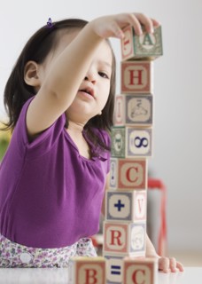 Toddler girl playing with blocks