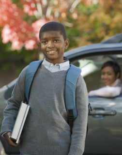 African mother dropping son off at school