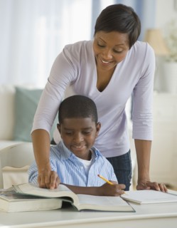 African mother helping son with homework