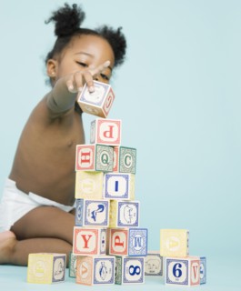 African American girl stacking wooden blocks