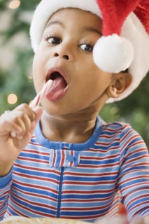 Close up of African American boy licking candy cane