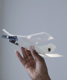 African woman holding airplane model