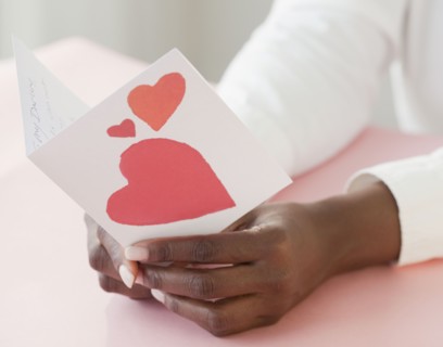 African woman holding Valentine's Day card