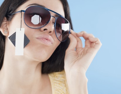 Hispanic woman trying on sunglasses