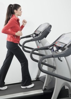 Hispanic woman walking on treadmill