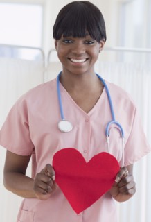 African nurse holding heart-shaped piece of paper