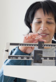 African woman weighing herself