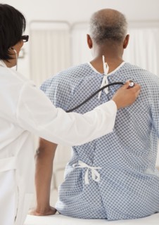 Doctor examining African man