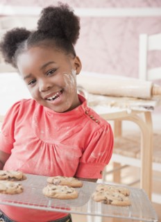 African girl holding fresh baked cookies