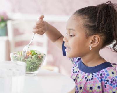 African girl eating salad