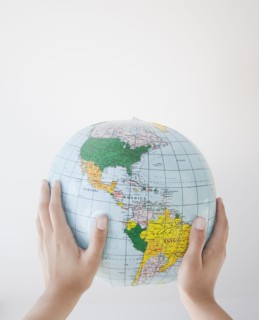 Woman holding inflatable globe