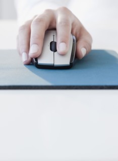 Woman clicking on computer mouse