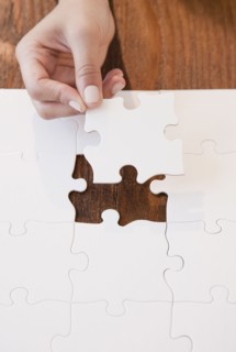 Woman completing jigsaw puzzle