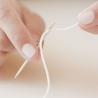 Woman threading needle