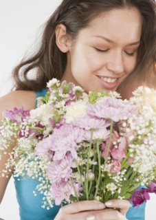 Mixed race woman holding bouquet of flowers