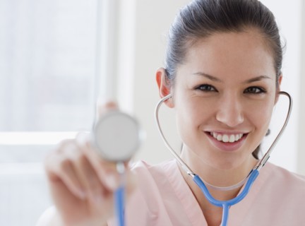 Mixed race nurse holding stethoscope