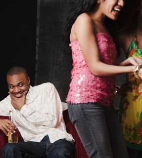 African man eyeing women in nightclub