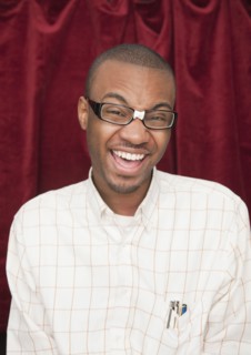 African man wearing taped eyeglasses and making a face