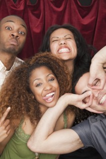 Friends making silly faces in photo booth