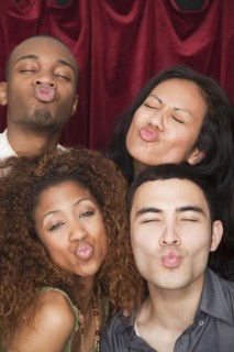 Friends puckering lips in photo booth
