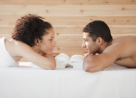 Couple laying face to face on massage table