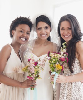 Bride and bridesmaids holding bouquets of flowers