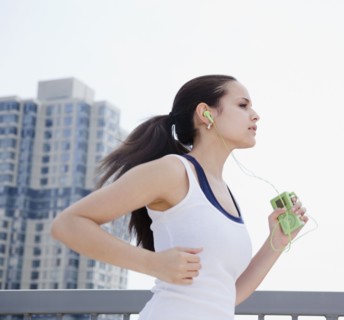 Mixed race woman jogging with mp3 player