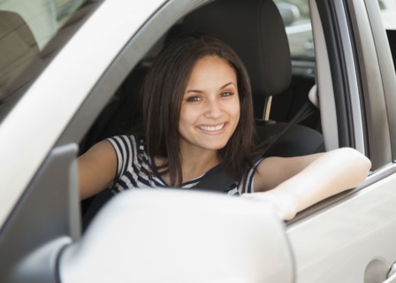 Mixed race woman driving car