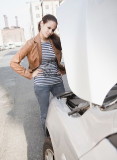 Mixed race woman having car trouble