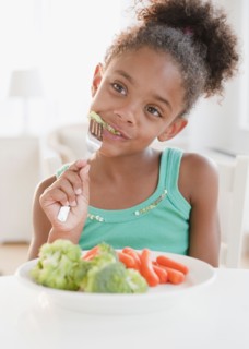 Mixed race girl eating healthy meal