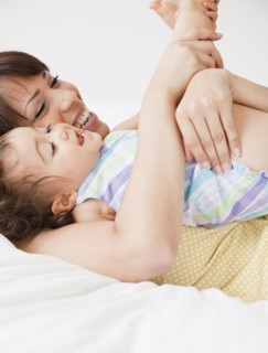 Hispanic mother playing with daughter