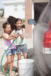 Hispanic girls washing car