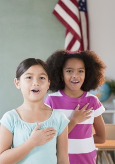 School girls pledging allegiance to the flag