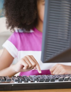Hispanic girl using computer