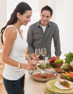 Hispanic couple cooking dinner