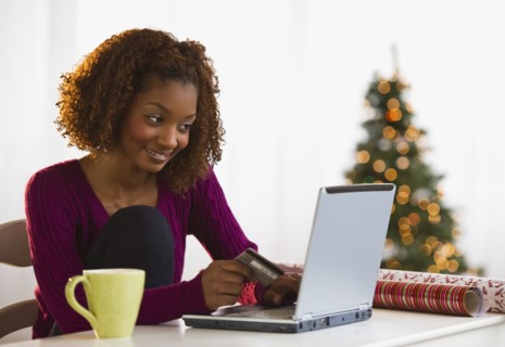 Mixed race woman Christmas shopping on internet with credit card