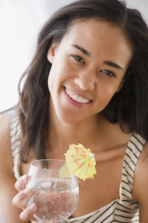 Mixed race woman drinking cocktail