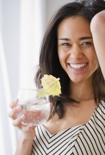 Mixed race woman drinking cocktail