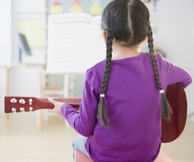 Chinese girl playing guitar