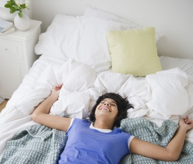 Hispanic woman laying on bed